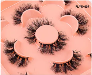 Macro shot of 5 pairs of thick multi-layered faux mink eyelashes in FLY5-009 packaging