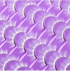 Detailed macro view of 20 pairs of white synthetic fiber eyelashes on a purple tray