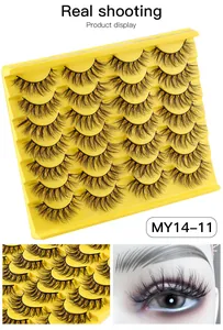 Macro view of 14 pairs of thick cross-design faux mink lashes in a yellow tray
