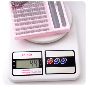 DIY cluster eyelash extension kit weighing 44g on a scale including glue and tweezers