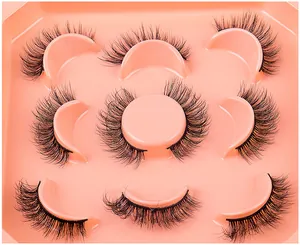 Detail view of seven pairs of thick faux mink eyelashes in a pink octagonal tray