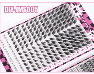 Macro detail of individual black DIY lash clusters on a pink checkerboard tray