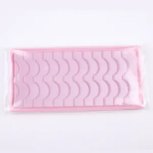 Pink plastic eyelash tray with crescent slots for 12 pairs of Russian volume lashes