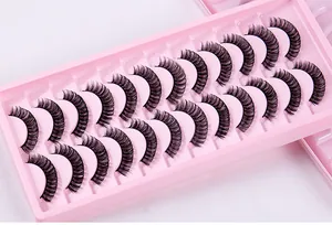 Detailed close-up of 20 pairs of black Russian curl false eyelashes in a pink display tray