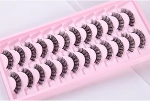 Macro detail of 10 pairs of dense Russian volume eyelashes on a pink display tray