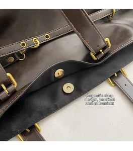 Detail of dark brown tote bag showing magnetic snap closure and golden hardware