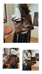 Detail view of a large vintage dark brown tote bag with decorative metal buckle straps