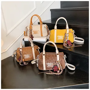 Detailed display of vintage Boston bags in beige, yellow, and leopard print options