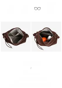 Spacious interior of suede crossbody bag with herringbone lining and zippered pocket