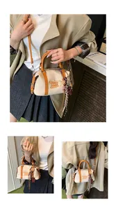 Models wearing a vintage beige Boston bag with brown trim and bear embroidery