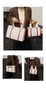 Detail view of large and small canvas tote bags with vintage brown leather stitching