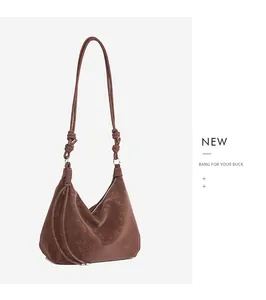 Close-up of the vintage brown hobo bag with unique knot detail and leather tassel