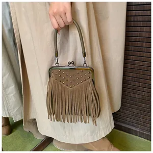 Detail of brown suede handbag with fringe, metal rivets and classic vintage metal clasp
