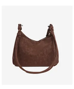 Close-up of the dark brown matte leather hobo bag with unique decorative knotted shoulder strap