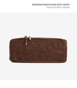Detail of dark brown matte faux leather handbag with slim drawstring and silver metal tips