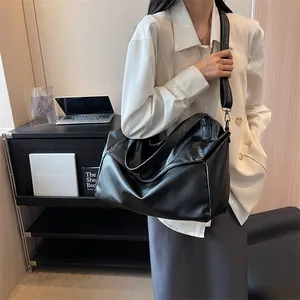 Large black pebbled leather tote bag with metallic rings for casual business style