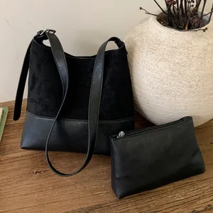 Vintage black large capacity shoulder tote bag with small pouch on wooden surface