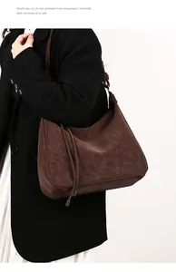 Detail of vintage textured dark brown suede tote bag featuring side drawstring accents