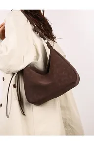 Detailed view of brown matte leather tote bag with unique knotted shoulder strap