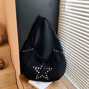Black suede hobo bag with silver rivet star studs and a retro crescent silhouette