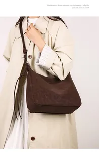 Detail shot of vintage dark brown suede tote bag featuring a knotted shoulder strap design