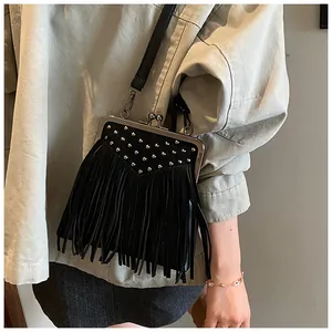 Macro detail of black fringe bag with silver studs and vintage metal clasp design