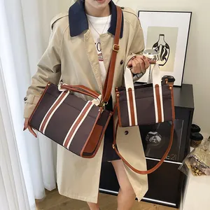 Retro canvas tote bag set with brown leather trim and striped strap for daily commute