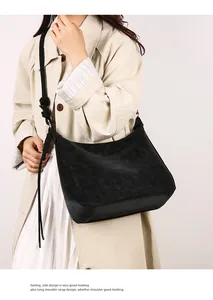 Detail of suede crossbody bag featuring thick knotted rope strap and matte leather texture