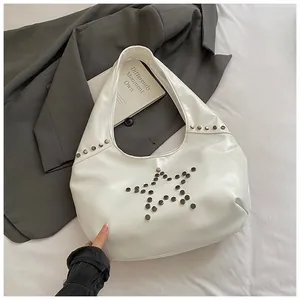 Vista detallada del bolso de hombro blanco con diseño de estrella de remaches estilo punk