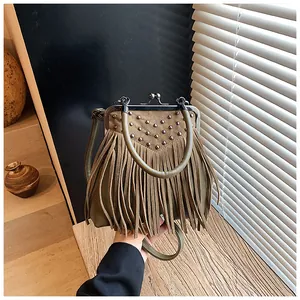 Detail of vintage olive green fringe bag featuring metallic studs and retro clasp closure