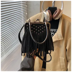 Detail of black fringe handbag with silver rivets and vintage ball-clasp closure