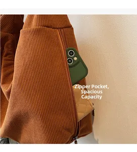 Close-up of corduroy tote bag featuring a functional side zipper pocket and interior space