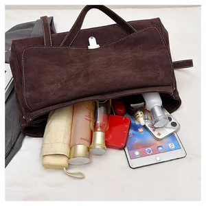 Internal view of brown suede shoulder bag showing large capacity for iPad and umbrella