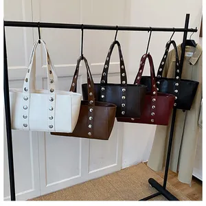 Close-up of stylish large tote bags featuring silver rivets in five assorted colors