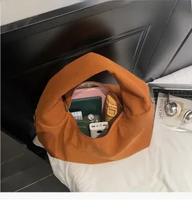 Interior view of large corduroy tote bag showing spacious storage for tablet and books