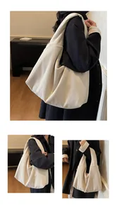 Detailed view of the off-white corduroy hobo bag showing ribbed fabric texture and large space