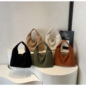 Detailed view of corduroy tote bags in black, khaki, white, green, and orange-brown shades