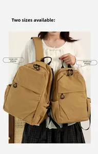 Comparison showing small and large khaki nylon backpacks on a female model