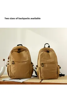 Two sizes of waterproof khaki nylon backpacks for outdoor travel shown in a set