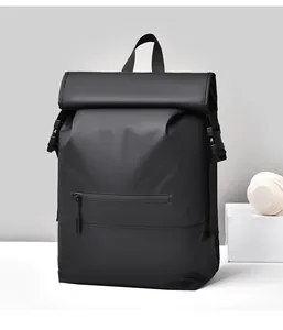 Detail of waterproof matte black backpack featuring a roll-top closure and front zipper