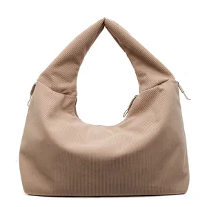 Minimalist beige corduroy tote bag with integrated top handles and zipper closure