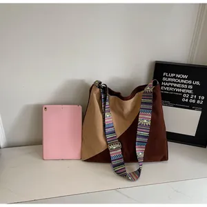 Detail of corduroy patchwork tote bag with ethnic pattern wide strap and metal buckle