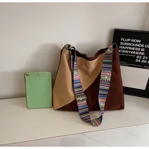 Detail of corduroy patchwork tote bag with ethnic bohemian wide shoulder strap