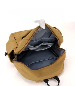 Detail view of khaki backpack interior showing multiple compartments and tablet sleeve