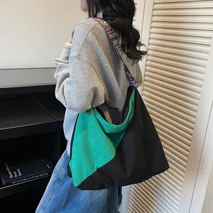Large corduroy hobo bag with contrast panel and ethnic style woven shoulder strap
