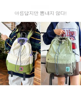 Detailed view of large capacity nylon drawstring backpacks with patchwork and logo embroidery