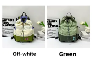 Detail of color-blocked nylon backpacks with drawstring closure and small embroidered labels