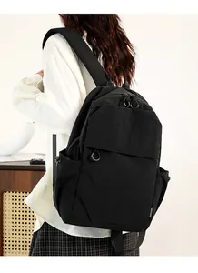 Detail of waterproof nylon backpack with smooth zipper closure and side logo tag