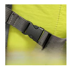 Detail of durable black plastic buckle on bright green nylon fabric with grey webbing