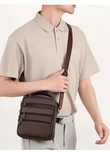 Detail of dark brown pebble leather shoulder bag for men with multiple zipper pockets